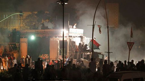 Pakistani protesters gather around a container which carries cricketer-turned-politician Imran Khan.