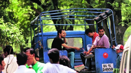 UPSC students wait outside the Tilak Marg police station for their fellow students who were detained by police. 