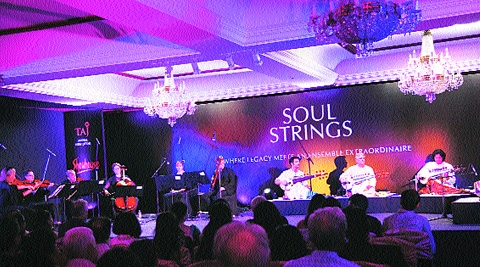 Musicians from the Britten Sinphonia (left) perform with Amjad Ali Khan and his sons.