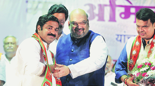 MNS MLA from Ghatkopar Ram Kadam with Amit Shah and state BJP chief Devendra Fadnavis at a rally in Pune on Thursday. (Source: Express photo by Pavan Khengre)