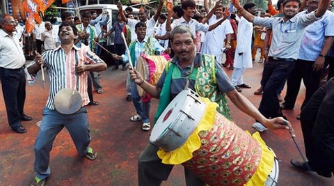 BJP activists dance in-front of their party office to celebrate their victory in Basirhat Dakshin Constituency in State Assembly by-election in Kolkata on Tuesday. (Source: PTI)
