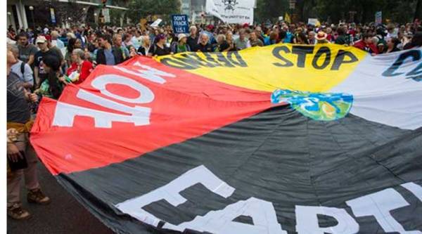 Marchers lift a banner during the People's Climate March in New York Sunday, Sept. 21, 2014. (Source: AP)