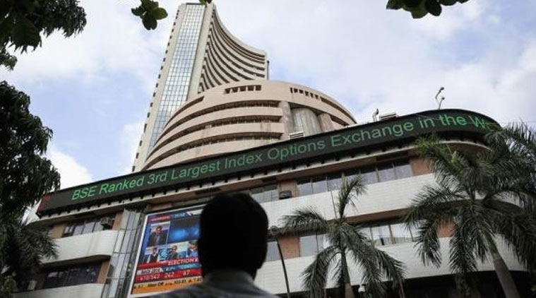 A man looks at a screen across the road displaying the election results on the facade of the Bombay Stock Exchange (BSE) building in Mumbai May 16, 2014. (Source: Reuters photo)