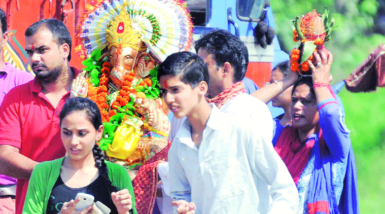 A family on way for Ganapati visarjan at Satluj in Ludhiana on Sunday. (Source: Express photo by Gurmeet Singh)