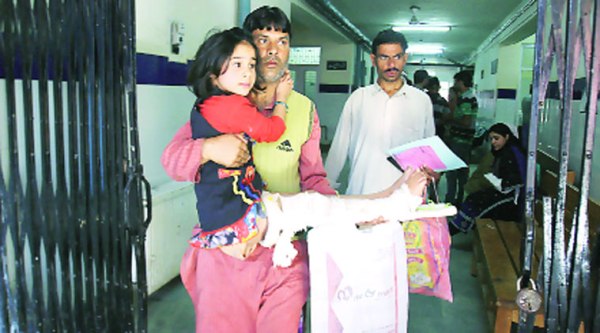 A man with his daughter at the Government Bone and Joints Hospital in Srinagar . (Express photo by Shuaib Masoodi)