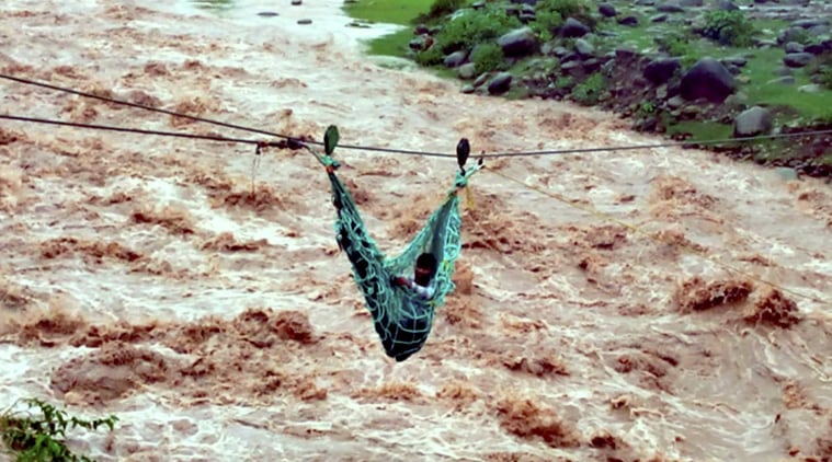 A flood-affected villager being rescued using a rope by the army at Thanamandi village of Rajouri on Friday. (Source: PTI)