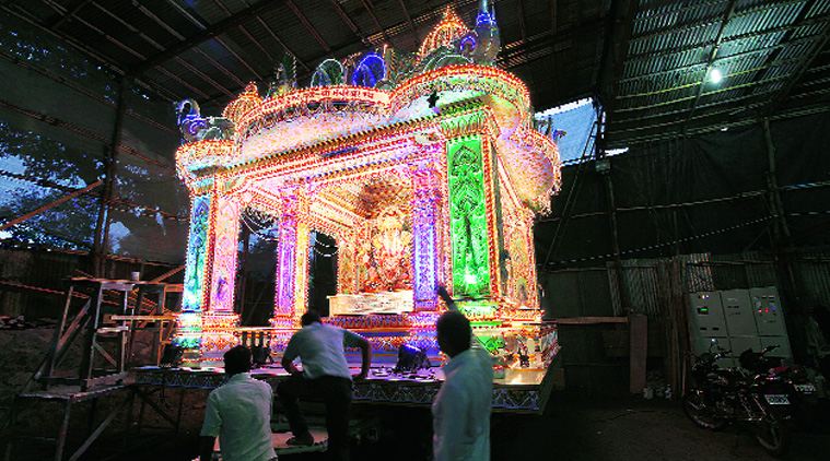 Volunteers of the famous Dagdusheth Ganapati Trust give final touches to the special chariot made for Monday’s immersion procession. (Source: Express photo by Pavan Khengre)