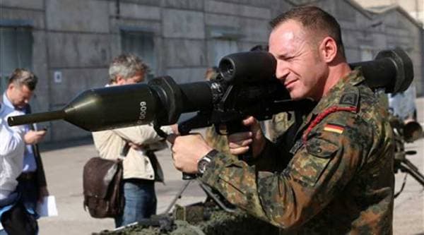 A member of the German army Bundeswehr presents a weapon which is part of a military aid for Iraq during a press event in Waren, northeastern Germany, Thursday, Sept. 18, 2014. (Source: AP)