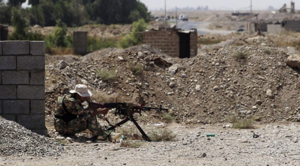 A Shiite militiaman takes his combat position in Amirli, 105 miles (170 kilometers) north of Baghdad, Iraq, Sunday, Aug. 31, 2014. (Source: AP)