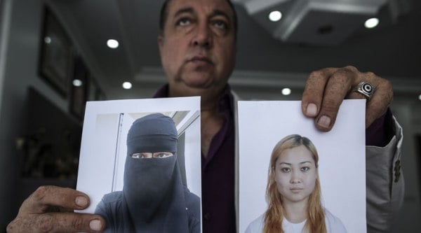 In this Friday, Sept. 19, 2014 photo, car salesman Sahin Aktan's family photos, his ex-wife Asiya Ummi Abdullah and their son Destan, are shown during an interview at his lawyer's office in Istanbul, Turkey. Aktan, 44, is the ex-husband of Asiya Ummi Abdullah, a 24-year-old Muslim convert who took their child to the territory controlled by Islamic State. (Source: AP)