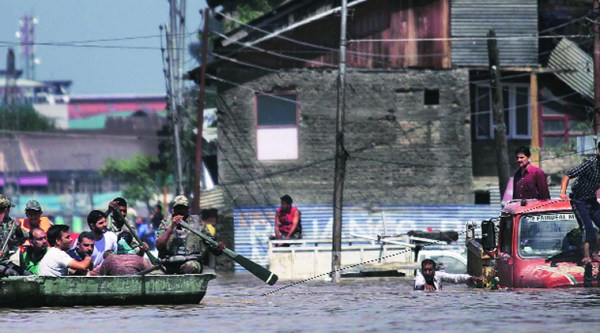 Army personnel rescue civilians at the Haft Chinar area in Srinagar on Wednesday. More than 77,000 people have been rescued by the Armed Forces and the NDRF so far.Source: Tashi Tobgyal