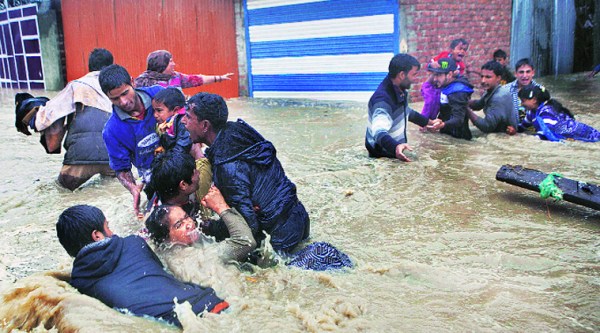 Residents of Srinagar struggle against sudden and strong water currents in this photo taken Thursday. Source: AP
