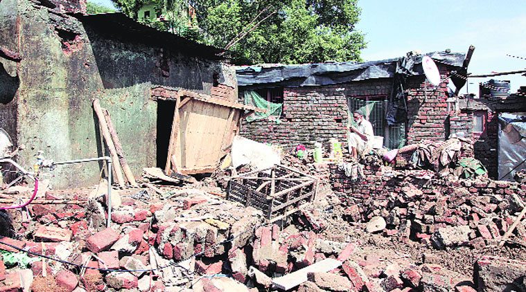 A man sits on the debris of his destroyed house on the banks of the Tawi in Jammu. ( Source:  AP )
