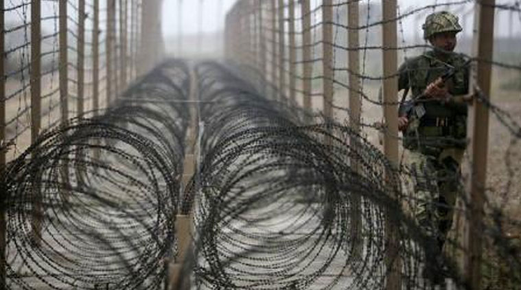 A Border Security Force (BSF) soldier patrols near the fenced border with Pakistan in Suchetgarh, southwest of Jammu. (Source: Reuters photo)