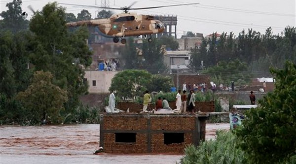 An Pakistani army helicopter hovers to rescue trapped people from a flooded area on the outskirts of Islamabad, Pakistan, Friday, Sept. 5, 2014. (AP Photo)