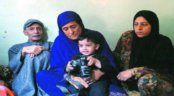 Shafat’s son with family members at their Srinagar home. ( Source: Express photo by Shuaib masoodi )