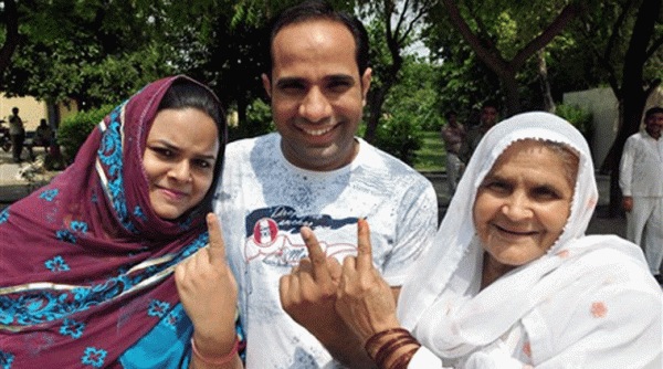 People show their inked fingers after voting in the assembly bypolls in Noida on Saturday. Source: PTI photo