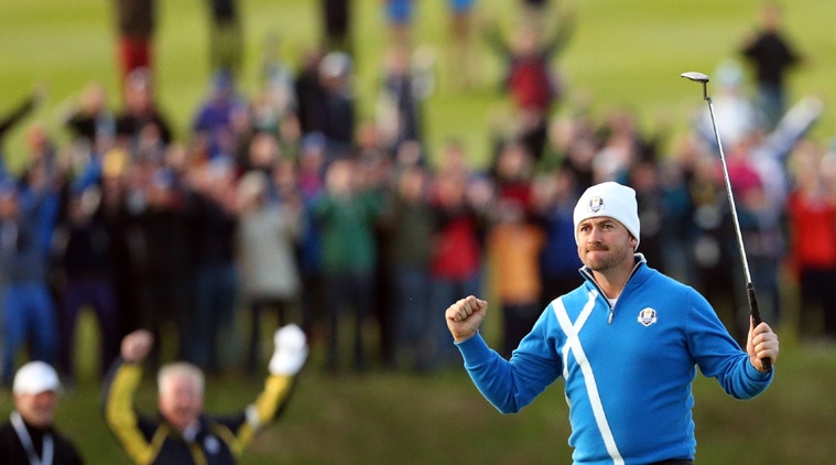 Europe’s Graeme McDowell celebrates putting out to win the match 3 and 2 to play during the foursomes match on the first day of the Ryder Cup golf tournament. (Source: AP) 