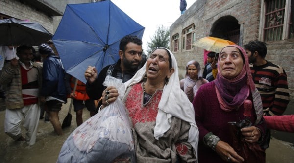 A Kashmiri woman cries as she is evacuated to a safer area, outside her home in Srinagar on Saturday. (AP Photo)