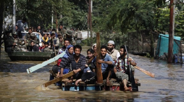 Kashmiri residents use makeshift rafts to rescue flood affected people in Srinagar,