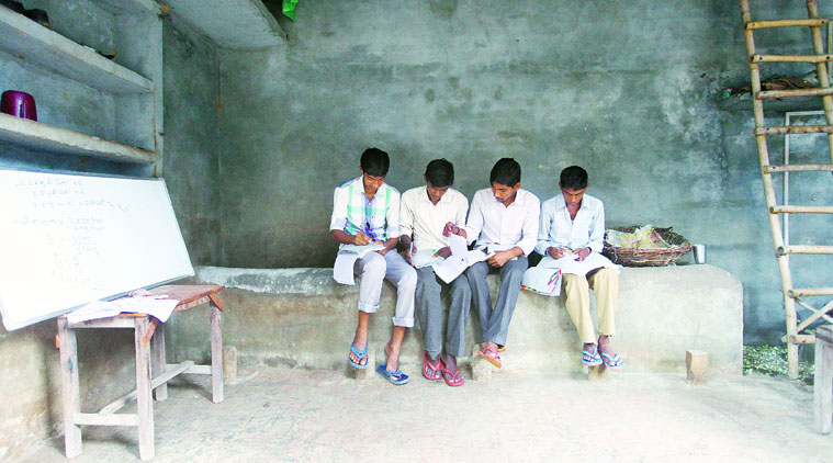Zahid (left) taking a break with fellow students, including Mukesh (third from left), at his tuition class. (Source: Express photo by Oinam Anand)