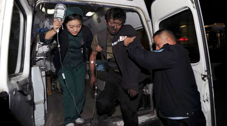 An injured miner is transferred to hospital after a coal mine collapsed in Tiechanggou township, China's Xinjiang regional capital of Urumqi Saturday, Oct. 25, 2014. (Source: AP photo)