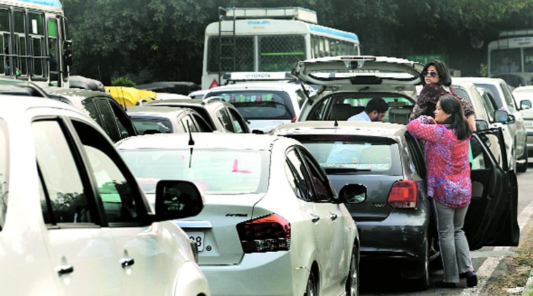 People wait during the traffic jam while the convoy of Prime Minister Narendra Modi crosses the Industrial Area roundabout in Chandigarh on Sunday. (Source: Express photo by Kamleshwar Singh)