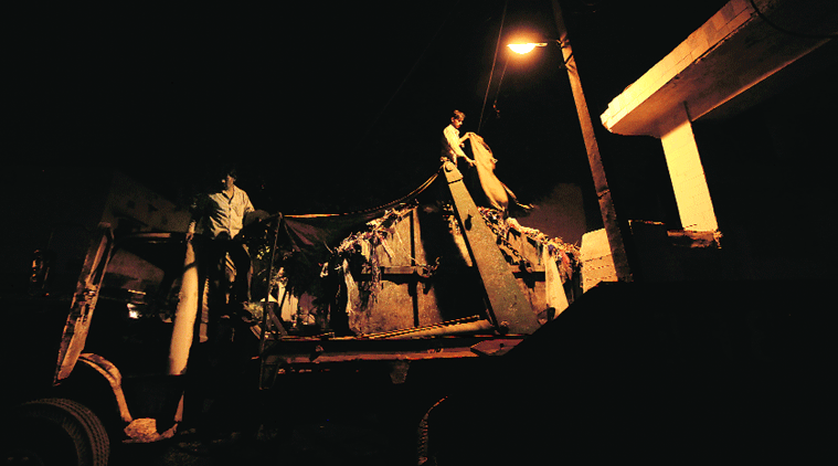 A little after midnight, a truck backs into one of the three dhalaons in Kotla Mubarakpur and takes away the trash.