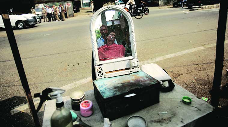 ALL SHAVE AND SOUND: People used the break for chores and some grooming.(Express photo by Praveen Khanna)