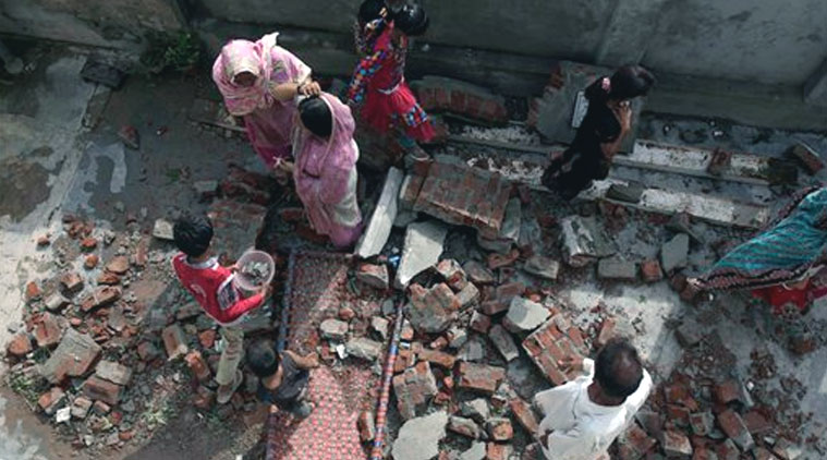Pakistani villagers walk through the rubble of their house, damaged during clashes between Pakistani forces and Indian's in Dhamala Hakimwala village in Pakistan's Punjab province, Wednesday, Oct. 8, 2014. (Source: AP photo)