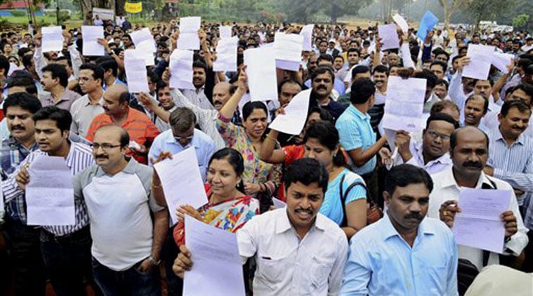Doctors, working in government hospitals, showing their resignation letters during a protest at freedom park in Bengaluru on Monday. (Source: PTI) 