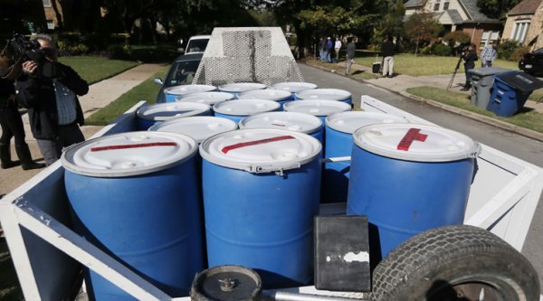 Disposal barrels are stationed outside the apartment of a healthcare worker, who treated Ebola patient Thomas Eric Duncan and tested positive for the disease, Monday, Oct. 13, 2014, in Dallas. (Source: AP)