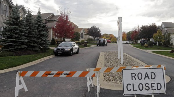 Tallmadge police cordon off a home in Tallmadge, Ohio, Wednesday, Oct. 15, 2014, where Amber Joy Vinson stayed over the weekend before flying home to Dallas. (Source: AP)