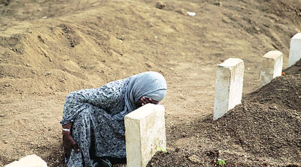 A woman mourns at the grave of her son, a Kurdish fighter who was killed in fighting with ISIS militants in Kobani at a cemetery in Suruc, Turkey.  (AP)