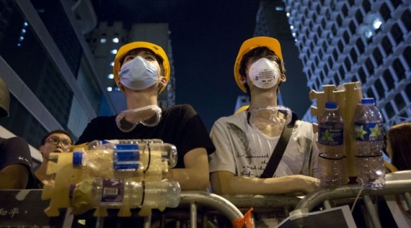 Protesters wear protective gear made by plastic bottle at a barricade in the Mong Kok district of Hong Kong, early Monday, Oct. 20, 2014. (Source: AP)