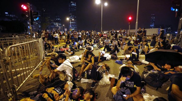 Student protesters sleep and wait at the entrance of the government complex where Hong Kong's Chief Executive Leung Chun-ying's office is located. (Source: AP)