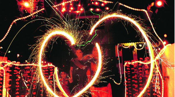 A family celebrates with crackers on the eve of Diwali; and a familiar car snarl. Cars and crackers together give city its worst air readings this time of the year.