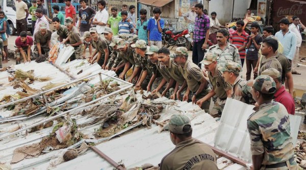 isakhapatnam: Armed Forces personnel carry out relief works in an area hit by the cyclonic storm Hudhud in Visakhapatnam on Tuesday. (Source: PTI)