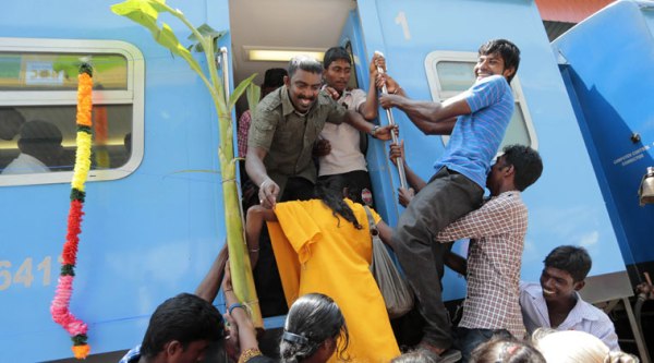 Sri Lankan ethnic Tamils board the "Queen of Jaffna" train decorated with banana plants and colorful flower garlands after it arrived at Jaffna in Sri Lanka, Monday, Oct. 13, 2014. (Source: AP)