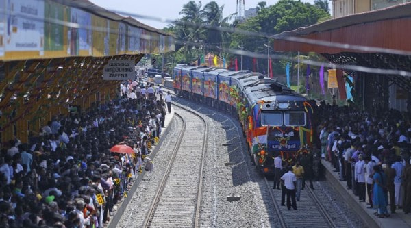Sri Lankan ethnic Tamils gather on platforms and welcome the train "Queen of Jaffna," as it arrives at Jaffna in Sri Lanka, Monday, Oct. 13, 2014. (Source: AP)
