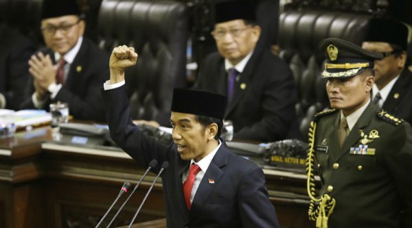 Indonesian President Joko Widodo, center, shouts "freedom" while raising his fist as he delivers his speech during his inauguration ceremony as the country's seventh president at the parliament building in Jakarta, Indonesia, Monday, Oct. 20, 2014. (Source: AP)