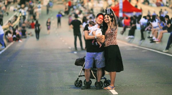 A couple takes a selfie as protesters leave an area outside the government headquarters in Hong Kong Monday. ( Source: Reuters )