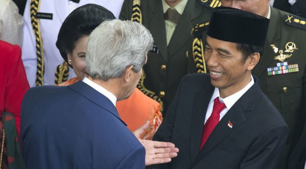 Indonesia's seventh President Joko Widodo, right, talks with U.S. Secretary of State John Kerry, left, after his inauguration at Parliament in Jakarta, Indonesia, Monday, Oct. 20, 2014. (Source: AP)
