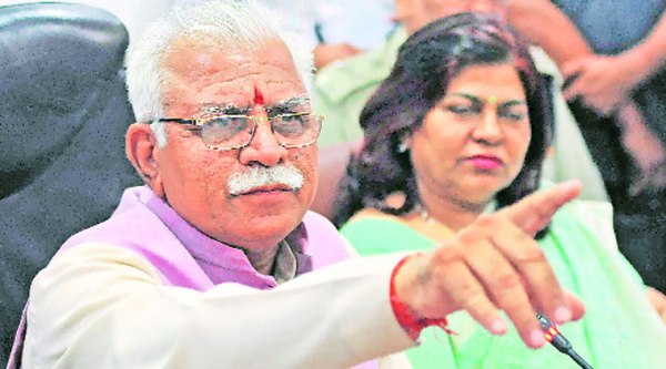Manohar Lal Khattar gestures while briefing journalists on what a cabinet meeting decided Monday.