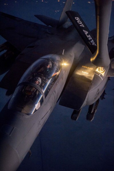 In this Tuesday, Sept. 23, 2014 photo provided by the U.S. Air Force, a F-15E Strike Eagle receives fuel from a KC-135 Stratotanker over northern Iraq after conducting airstrikes in Syria. U.S. coalition-led warplanes struck Islamic State group militants near the northern Syrian town of Kobani, also known as Ayn Arab, near the Turkish border for the first time Saturday, Sept. 27, 2014. (Source: AP Photo/U.S. Air Force)