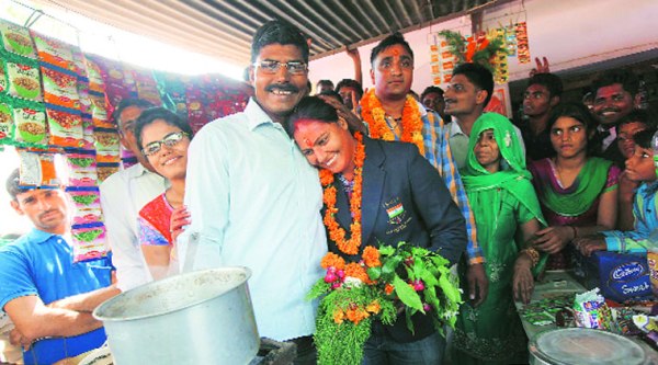 (Top) Manju gets a rousing reception upon her return to her native village in Chandgothi, Churu district of Rajasthan. (Above) at her father’s tea stall. Vijay (left) would do extra shifts to take care of her sporting needs.   