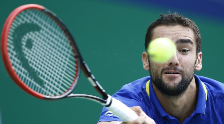 Marin Cilic of Croatia returns a shot during his men's singles tennis match against Ivo Karlovic (Source: Reuters)