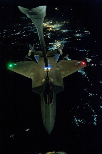 In this Friday, Sept. 26, 2014 photo, released by the U.S. Air Force, a U.S Air Force KC-10 Extender refuels an F-22 Raptor fighter aircraft prior to strike operations in Syria.(Source: AP)