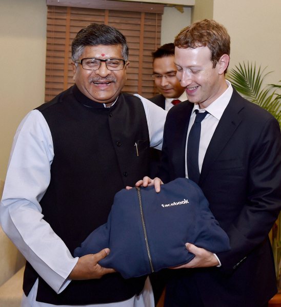 Information Technology Minister, Ravi Shankar Prasad receives a present from Facebook CEO Mark Zuckerberg during a meeting  in New Delhi on Friday. (Source: PTI)
