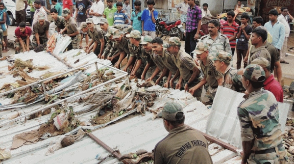 Armed Forces personnel carry out relief works in an area hit by the cyclonic storm Hudhud in Visakhapatnam. (Source: PTI Photo)